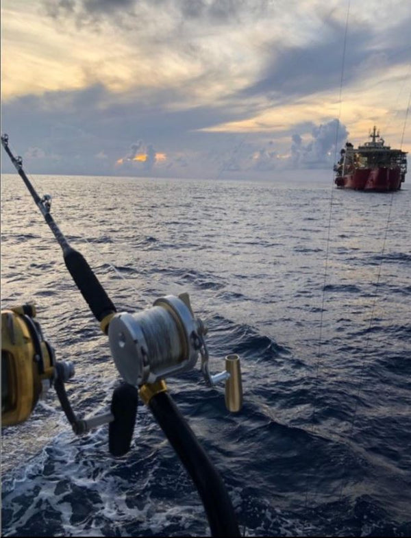 Picture of fishing rods near an offshore oil rig
