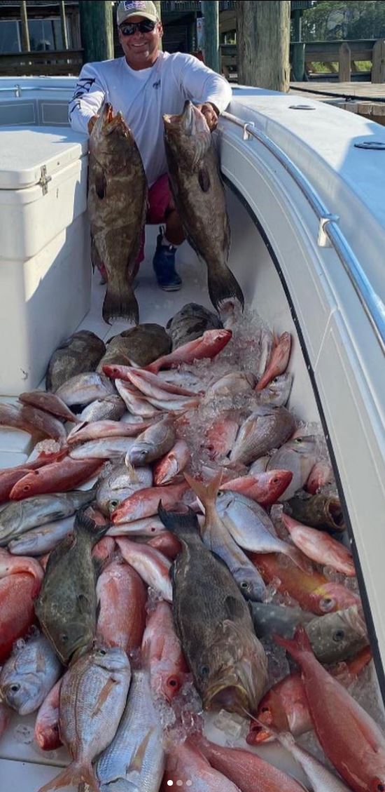 Man in Boast with lots of Snapper and Grouper Fish