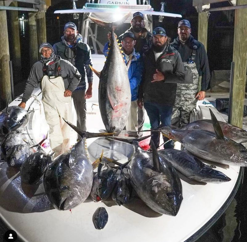 Group of men with Tuna on boat