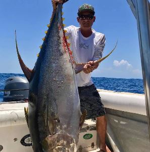 Man holding up yellowfin tuna