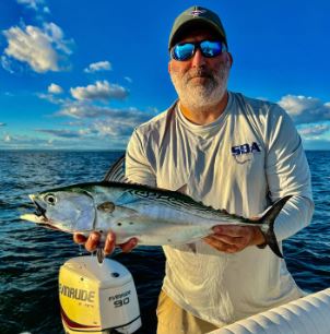 Picture of man holding albacore tuna fish