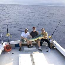 3 people holding Mahi Mahi Fish